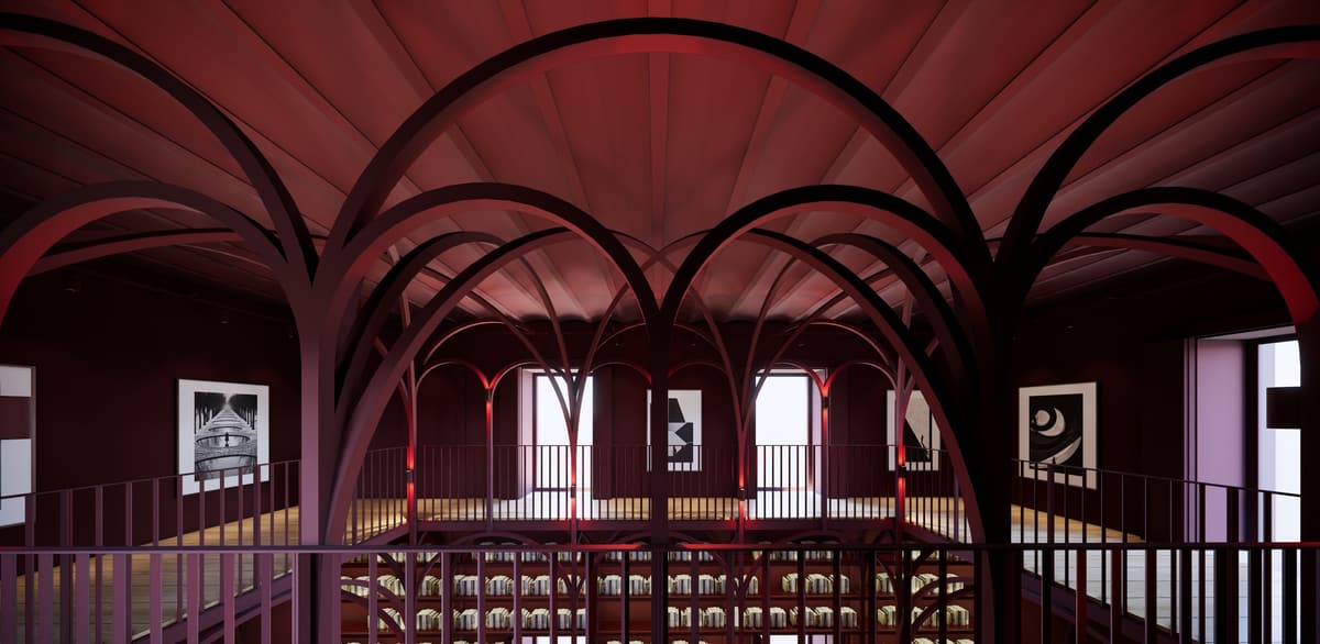 Upper gallery of the Alentejo library under dark red arches, with framed prints and a railing over the shelves