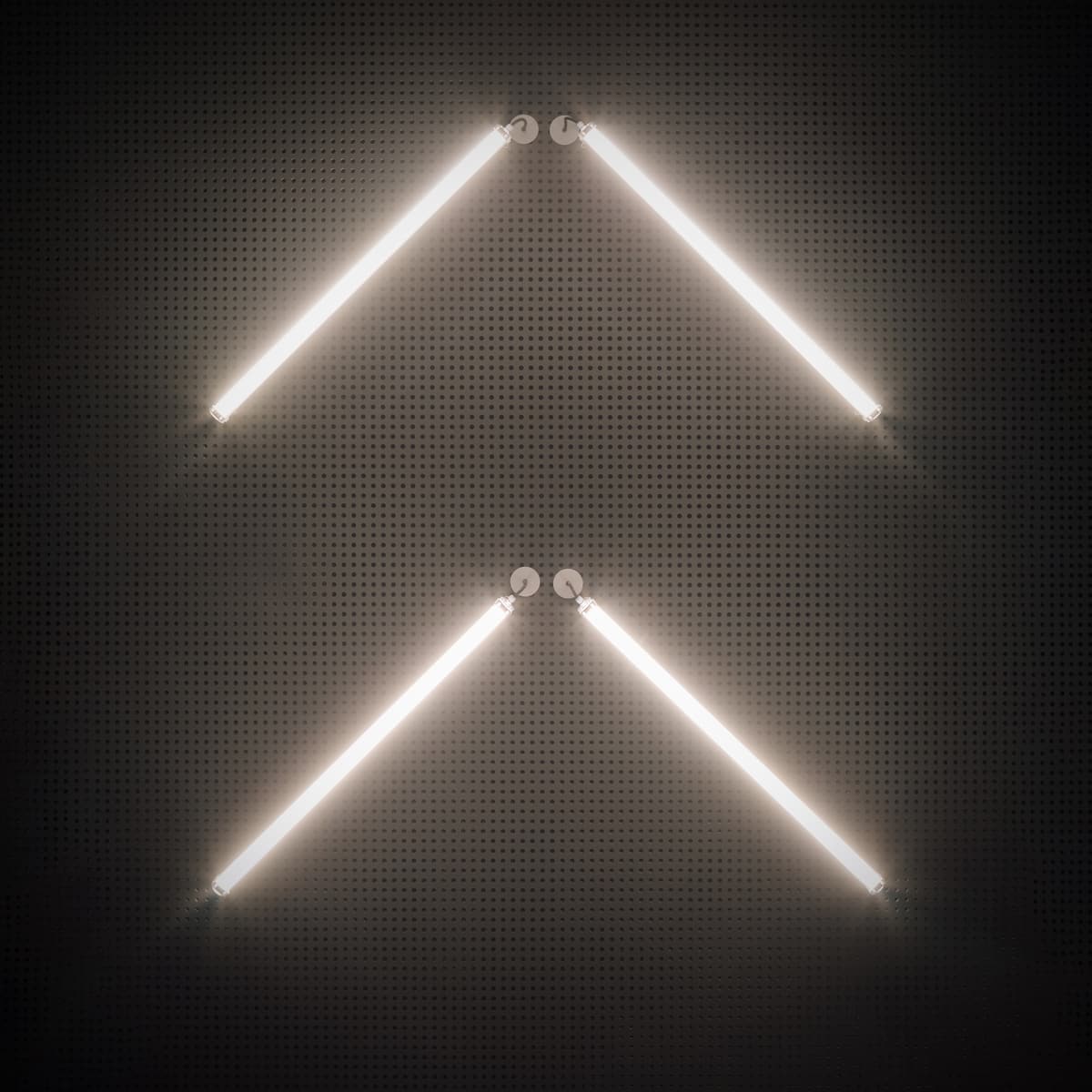 Close-up of four fluorescent tubes forming two chevrons on a dark perforated ceiling