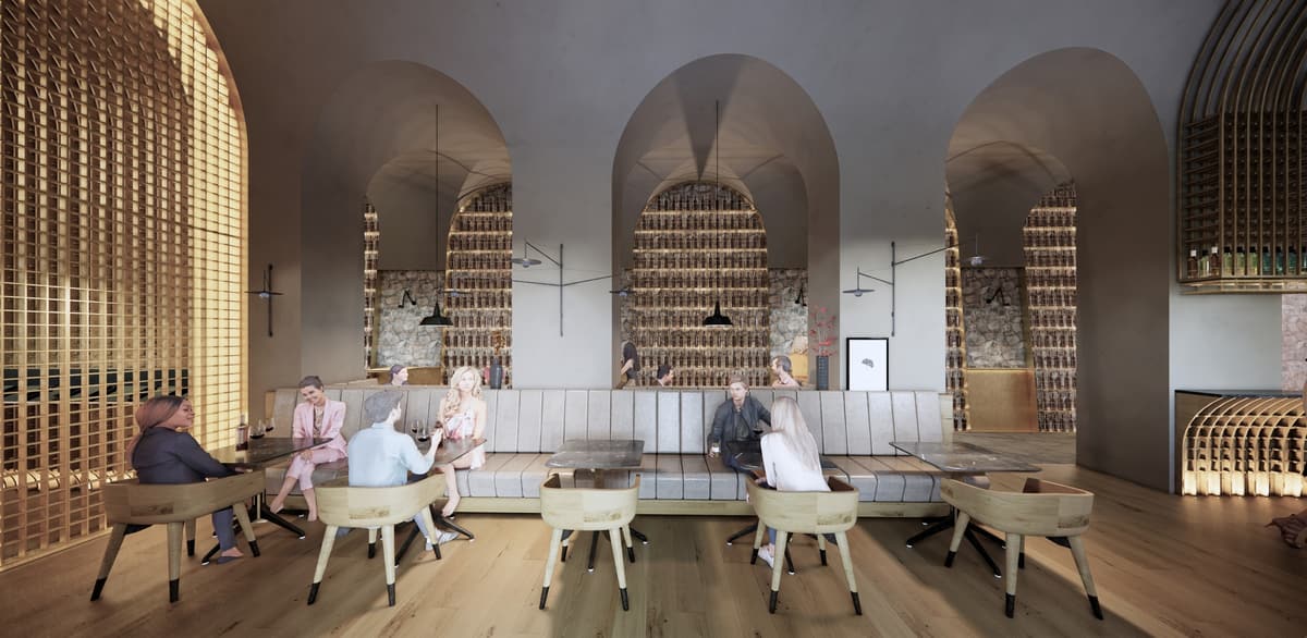 Seating area of the Salvador wine bar with a long banquette, wooden chairs and arched niches lined with bottles